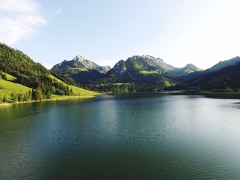 Scenic view of lake and mountains against sky