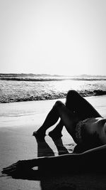 Shadow of woman on beach against clear sky