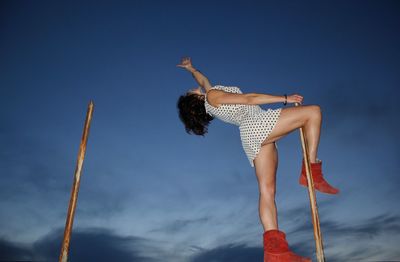 Low angle view of woman against the sky