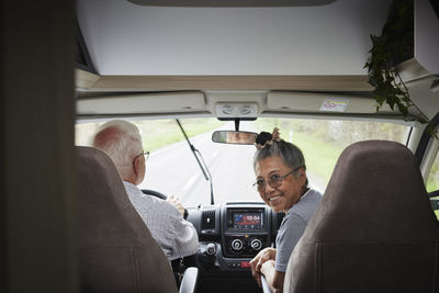 Senior couple traveling by van