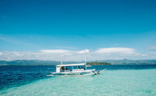 Scenic view of sea against blue sky