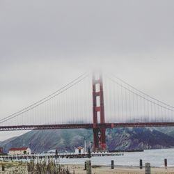 Golden gate bridge over sea against sky