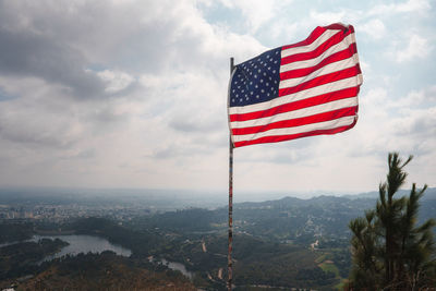 Low angle view of american flag against sky