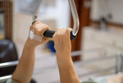 Cropped hands of woman exercising in gym