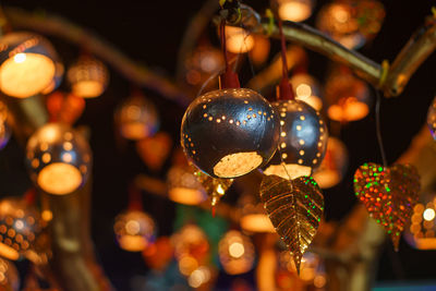 Low angle view of illuminated christmas lights hanging at night