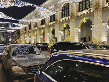 Cars on street by buildings in city