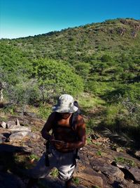 Man wearing hat while standing on mountain