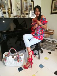 Portrait of woman sitting on chair at home