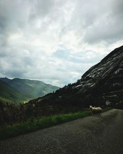 Scenic view of mountains against cloudy sky