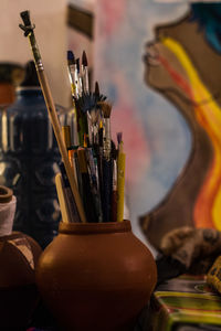 Close-up of paintbrushes in container on table