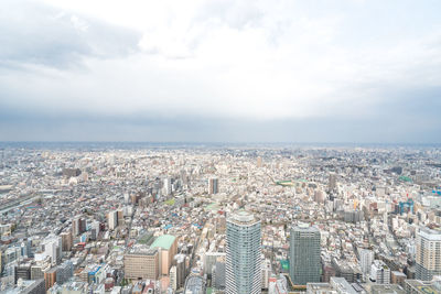 High angle view of city buildings against sky