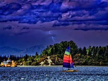 Scenic view of calm lake against cloudy sky