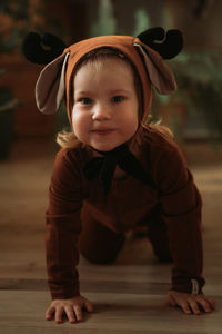 Portrait of toddler baby girl in rudolph reindeer costume. christmas concept christmas tree