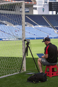 Man looking at camera while sitting on seat