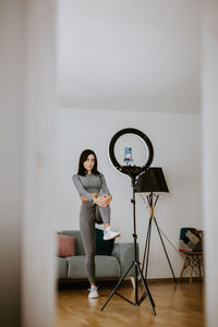 Woman sitting on table at home