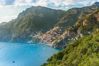 Scenic view of sea and mountains against sky