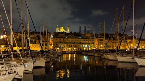 Sailboats in harbor at night