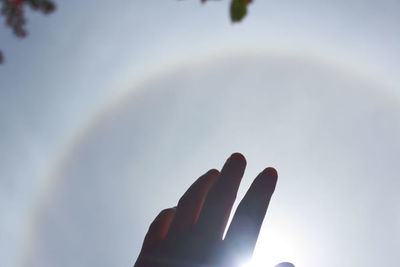 Low angle view of hand against sky