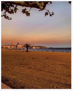 Scenic view of beach against sky during sunset