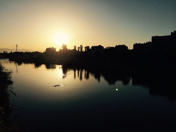 Reflection of buildings in water at sunset