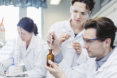 Team of scientists examining sample at laboratory