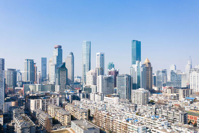 Modern buildings in city against clear sky