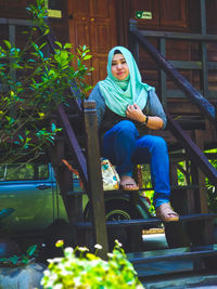 Portrait of young woman sitting on seat