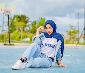 Portrait of smiling young woman sitting outdoors