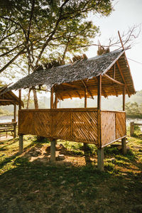 House by trees on field