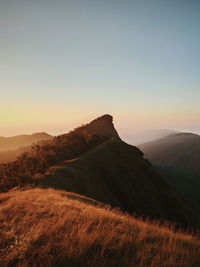 Scenic view of mountains against clear sky during sunset