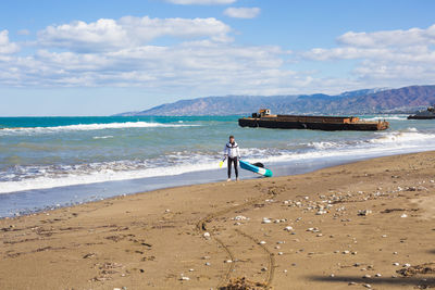 People on beach against sky