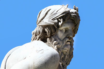 Low angle view of statue against clear blue sky