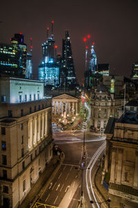 High angle view of illuminated city against sky at night