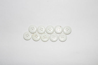 High angle view of coins on white background