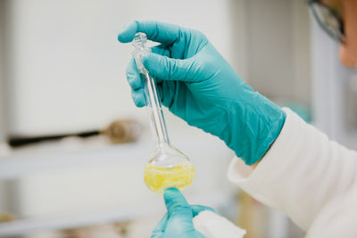 Cropped hand of scientist holding flask in laboratory