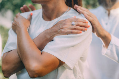 Reiki lesson. reiki instructor with hands over shoulders of the course attendee, transferring energy