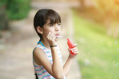 Portrait of girl holding bubbles