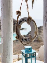 Close-up of welcome sign at beach