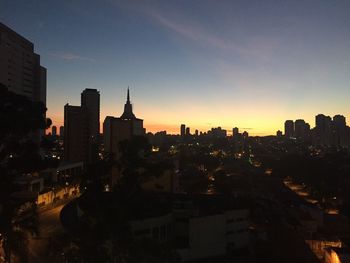 High angle view of illuminated buildings against sky during sunset