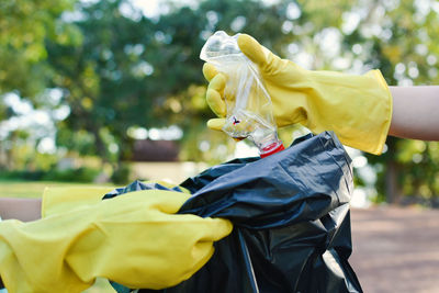 Close-up of people collecting garbage