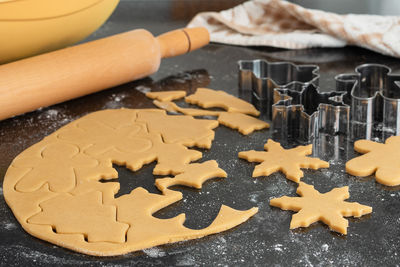 Making christmas cookies - raw dough and pastry molds. christmas background.