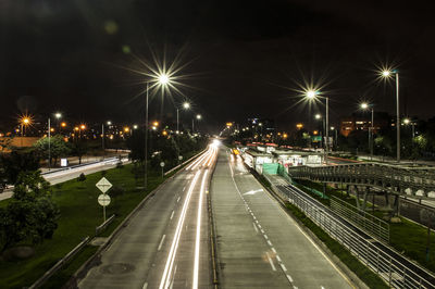 High angle view of light trails on road at night