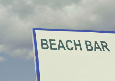 Low angle view of information sign against sky