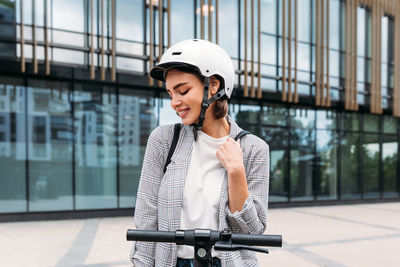 Young woman looking at bicycle