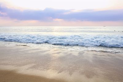 Scenic view of beach against sky during sunset