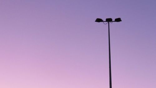 Low angle view of street light against purple sky