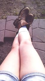 Close-up of woman lying on wall