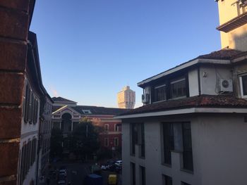 Low angle view of buildings against clear blue sky