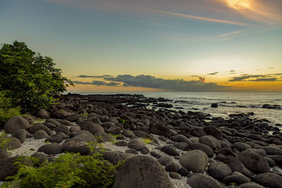 Sunset on the rocky beach of albion, mauritius.