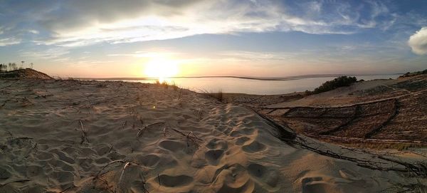 Panoramic view of beach against sky during sunset